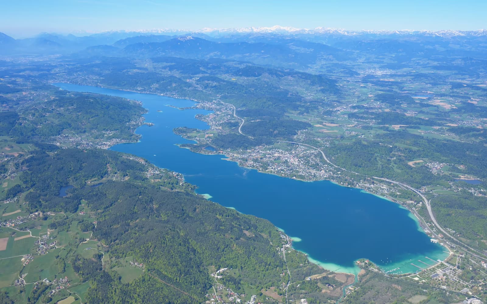 Luftbild des Wörthersees mit Uferorten und umliegender Landschaft